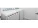 Laundry room featuring a modern side-by-side washer and dryer set at 8706 Seasalt Loop, Englewood, FL 34224
