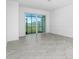 Bright living room with tiled floors, sliding glass doors, and neutral paint at 8706 Seasalt Loop, Englewood, FL 34224