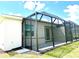 Exterior view of a screened porch, showcasing its design and integration with the home's architecture at 8706 Seasalt Loop, Englewood, FL 34224