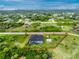 Discover this charming home with pool, outbuilding, and fenced yard, nestled in a peaceful and green Cape Coral setting at 9954 Audrey St, Port Charlotte, FL 33981