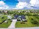 Spacious home with a well-manicured lawn, lush landscaping, and a shed at 9954 Audrey St, Port Charlotte, FL 33981