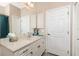 A bathroom with white cabinets, marble countertops, and a decorative mirror at 9954 Audrey St, Port Charlotte, FL 33981
