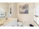 A half bathroom featuring a white vanity and a coastal-themed painting at 9954 Audrey St, Port Charlotte, FL 33981