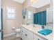 A clean and bright bathroom with a marble countertop and a large mirror at 9954 Audrey St, Port Charlotte, FL 33981