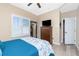 Bedroom featuring a TV on a bureau next to a white shuttered window at 9954 Audrey St, Port Charlotte, FL 33981