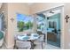 Bright breakfast nook with views of the pool through a large sliding glass door at 9954 Audrey St, Port Charlotte, FL 33981