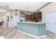 Open kitchen with stainless steel appliances, custom wood cabinets, and modern countertops at 9954 Audrey St, Port Charlotte, FL 33981
