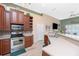 Modern kitchen with stainless steel appliances, dark wood cabinets, and counter seating at 9954 Audrey St, Port Charlotte, FL 33981