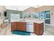 Bright, open kitchen featuring modern appliances, wood cabinets and a lovely breakfast bar at 9954 Audrey St, Port Charlotte, FL 33981
