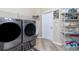 The laundry room features modern washer/dryer units and ample storage space at 9954 Audrey St, Port Charlotte, FL 33981