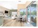 Open living area with view to the pool through sliding glass doors and lots of natural light at 9954 Audrey St, Port Charlotte, FL 33981