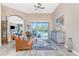 Open living room with a view of the pool through sliding glass doors and elegant furnishings at 9954 Audrey St, Port Charlotte, FL 33981