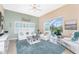Relaxing living room with plush seating, neutral tones, and serene view of the backyard and pool at 9954 Audrey St, Port Charlotte, FL 33981