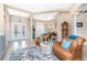 Bright, open living room with high ceilings, wood floors, and comfortable leather chairs at 9954 Audrey St, Port Charlotte, FL 33981