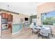 Open concept living room and kitchen with view to the pool through sliding glass doors at 9954 Audrey St, Port Charlotte, FL 33981