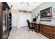 A home office with built-in shelving, desk, chair, and mounted swords at 9954 Audrey St, Port Charlotte, FL 33981