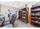 A home office with wood shelving, a shuttered window, and eclectic decor at 9954 Audrey St, Port Charlotte, FL 33981
