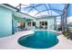 Relaxing screened pool area with patio seating and bright turquoise accents at 9954 Audrey St, Port Charlotte, FL 33981