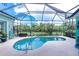 Inviting screened pool with a spacious deck and tropical garden views at 9954 Audrey St, Port Charlotte, FL 33981