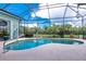Inviting screened pool area with a spacious deck and views of the backyard at 9954 Audrey St, Port Charlotte, FL 33981