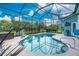 Screened-in swimming pool with clear blue water and a peaceful outdoor space at 9954 Audrey St, Port Charlotte, FL 33981