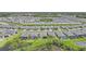 Expansive aerial view of a community with well-maintained homes, landscaping, and water features at 11383 Burgundy Dr, Venice, FL 34293