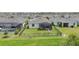 Aerial view of fenced backyard with screened lanai with hot tub, and lush landscaping at 11383 Burgundy Dr, Venice, FL 34293
