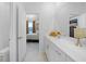 Bathroom featuring a large vanity with double sinks and a view into the luxurious main bedroom at 11383 Burgundy Dr, Venice, FL 34293