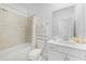 Clean, white bathroom featuring a shower-tub combo and white vanity with modern fixtures at 11383 Burgundy Dr, Venice, FL 34293