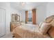 Bright bedroom features tile flooring, a chandelier, and golden furniture with beautiful decor at 11383 Burgundy Dr, Venice, FL 34293