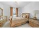 Bright bedroom features tile flooring, a chandelier, and golden furniture with beautiful decor at 11383 Burgundy Dr, Venice, FL 34293