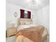 Bright bedroom features tile flooring, a chandelier, and tufted headboard at 11383 Burgundy Dr, Venice, FL 34293