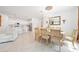 Spacious dining area featuring a chandelier, a large dining table, and a view of the kitchen at 11383 Burgundy Dr, Venice, FL 34293