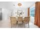 Elegant dining room with tiled floors, chandelier, and a view of the kitchen at 11383 Burgundy Dr, Venice, FL 34293