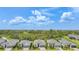 A row of homes backs to beautiful green space, creating privacy, with lush landscaping and manicured lawns at 11383 Burgundy Dr, Venice, FL 34293