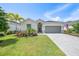 Charming single-story home featuring a paver driveway, two-car garage, and meticulously maintained landscaping at 11383 Burgundy Dr, Venice, FL 34293