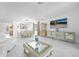 Open-concept living room and dining area with tiled floors, modern decor and plenty of natural light at 11383 Burgundy Dr, Venice, FL 34293