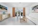 Comfortable living room with bright walls, a modern couch and a sliding glass door to the patio at 11383 Burgundy Dr, Venice, FL 34293