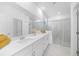 Bright and spacious main bathroom with double sinks, quartz countertops, and a glass-enclosed shower at 11383 Burgundy Dr, Venice, FL 34293