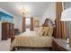 Elegantly furnished main bedroom features a decorative chandelier, custom draperies, and comfortable seating area at 11383 Burgundy Dr, Venice, FL 34293