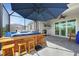 Relax in your screened lanai with a hot tub, outdoor bar, ceiling fan, and wall mounted television at 11383 Burgundy Dr, Venice, FL 34293