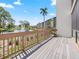 Enjoy community views from this spacious balcony, complete with wooden railings and peaceful scenery at 1144 Bird Bay Way # 102, Venice, FL 34285