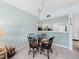 Dining area adjacent to the kitchen, lit by a stained glass lamp, with views of the appliances and cabinets at 1144 Bird Bay Way # 102, Venice, FL 34285