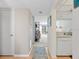 Bright foyer with hardwood floors leading to the living area and adjacent to a modern kitchen space at 1144 Bird Bay Way # 102, Venice, FL 34285