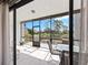 Screened in lanai with tile flooring and outdoor furniture, overlooking the lake at 1144 Bird Bay Way # 102, Venice, FL 34285