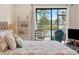 Comfortable bedroom featuring a large window overlooking the lake, creating a serene retreat at 1144 Bird Bay Way # 102, Venice, FL 34285