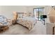 Cozy main bedroom with carpet, complemented by a slider with access to the screened porch at 1144 Bird Bay Way # 102, Venice, FL 34285