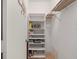 A pantry with white shelves and a metal storage rack above; perfect for organized storage at 1144 Bird Bay Way # 102, Venice, FL 34285