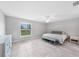 Serene bedroom featuring neutral walls, a ceiling fan, a window, and tiled floors at 12112 Helios Ave, Port Charlotte, FL 33981