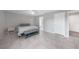 Comfortable bedroom featuring tiled floors, neutral tones, a ceiling fan, and ample closet space at 12112 Helios Ave, Port Charlotte, FL 33981
